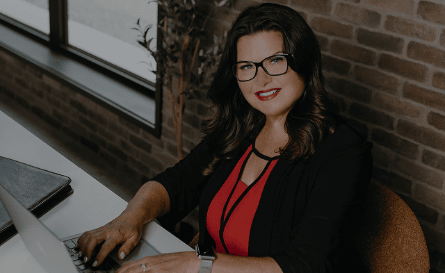 Woman working at computer with MLS boards connection